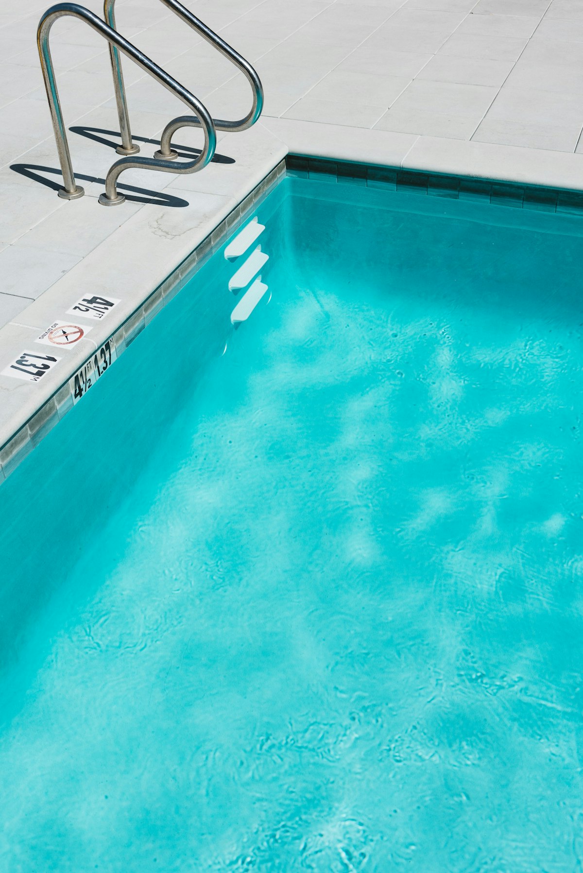 Bright blue backyard swimming pool ready for a party