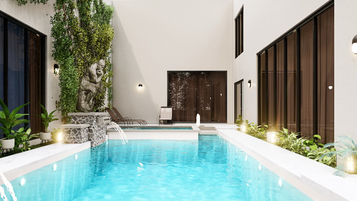 Backyard swimming pool surrounded by trees in autumn